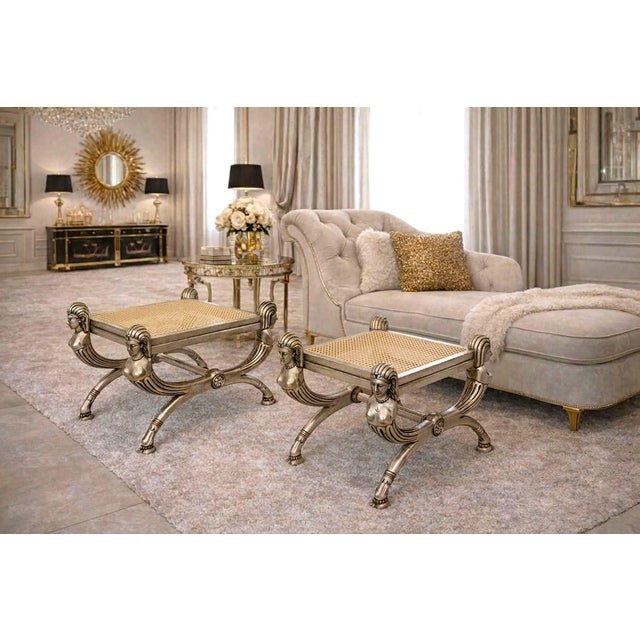 Offering a pair of vintage Italian rattan hand carved wood Spanish Empire benches, circa Late 20th Century. The design was...