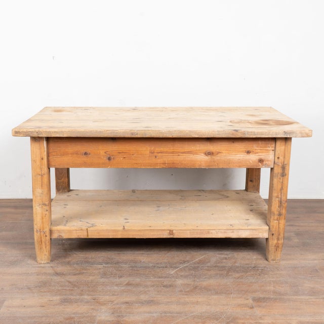 Late 19th century Hungarian work table, crafted in pine with a sturdy utilitarian form. The broad top shows generations of...