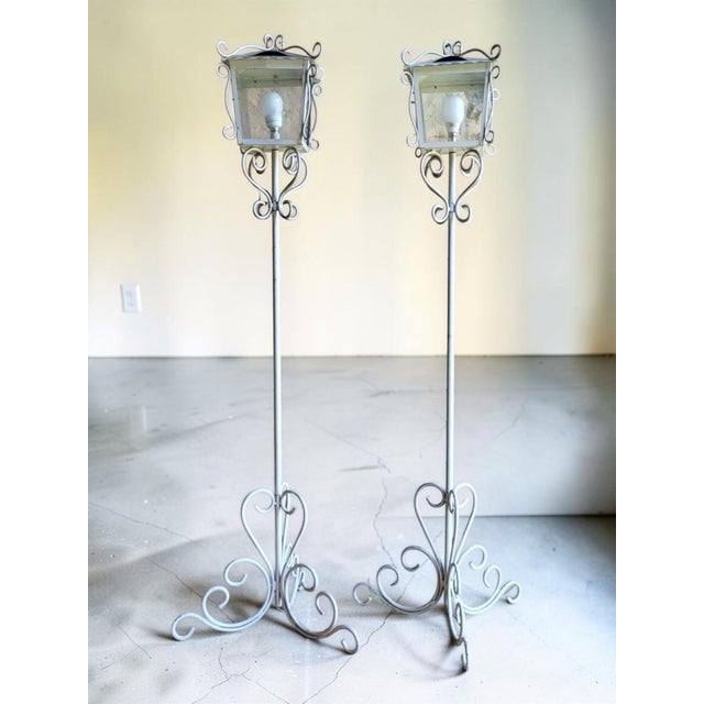 Pair of indoor/outdoor floor lamps in white lacquered wrought iron. Circa 1950-60. Height 171 cm. Footprint 54/55 cm. In...