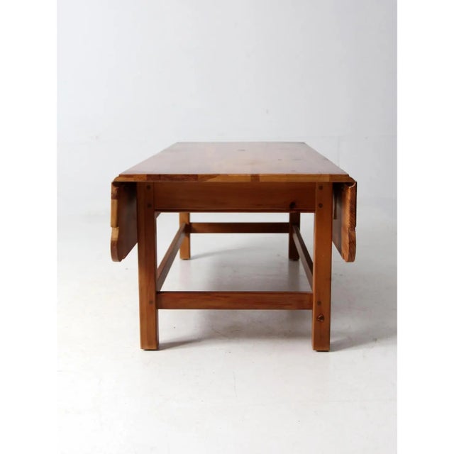 Vintage pine drop-leaf coffee table attributed to Ethan Allen, showcasing classic American traditional style. Crafted in...