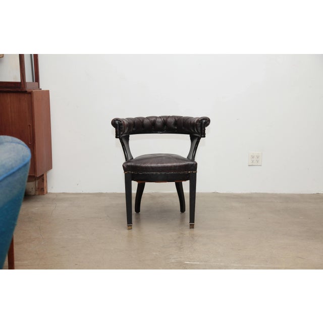A English oak library chairs with tufted leather back rails, leather seats nailed with black studs.