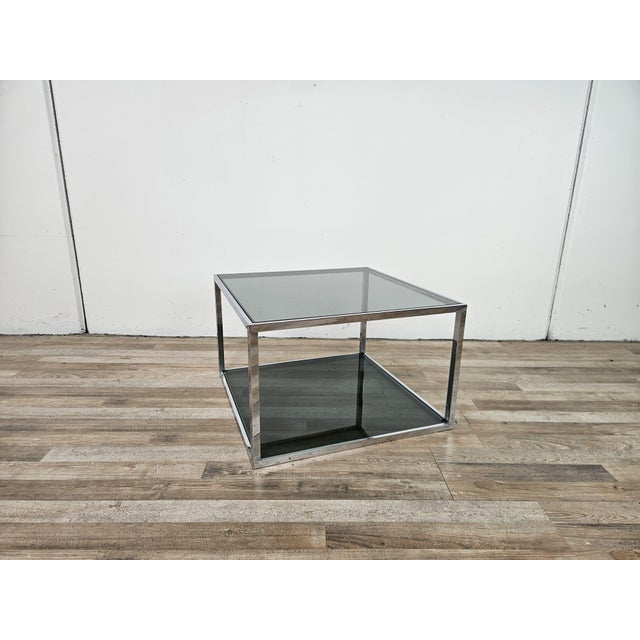 Vintage 1970s coffee table with an all-chrome steel frame and a double smoked glass shelf. It shows normal signs of wear...
