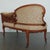 This exquisitely carved Victorian conversation settee captures the romantic elegance and craftsmanship of the late 19th...