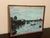 This vintage oil painting is a beautiful piece of art that features a canal scene. The painting is signed and produced in...