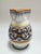 Hand-painted pottery pitcher from Italy featuring the iconic Ricco pattern with scrollwork and floral accents, inspired by...