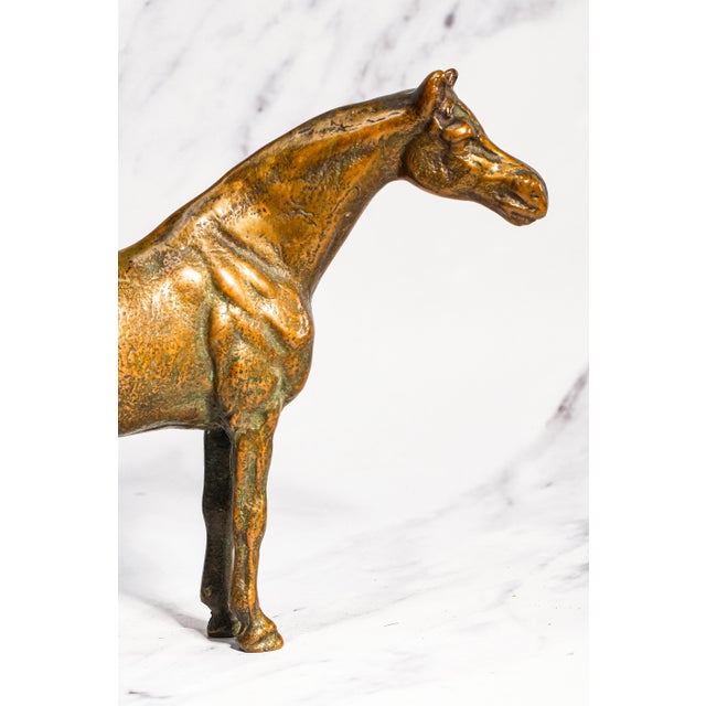 A striking and timeless decorative piece, this vintage bronze horse sculpture captures the strength, grace, and quiet...