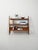 Inverted V-shaped side structure with exposed screws, three teak shelves; the top one is inclined for display. Simple,...