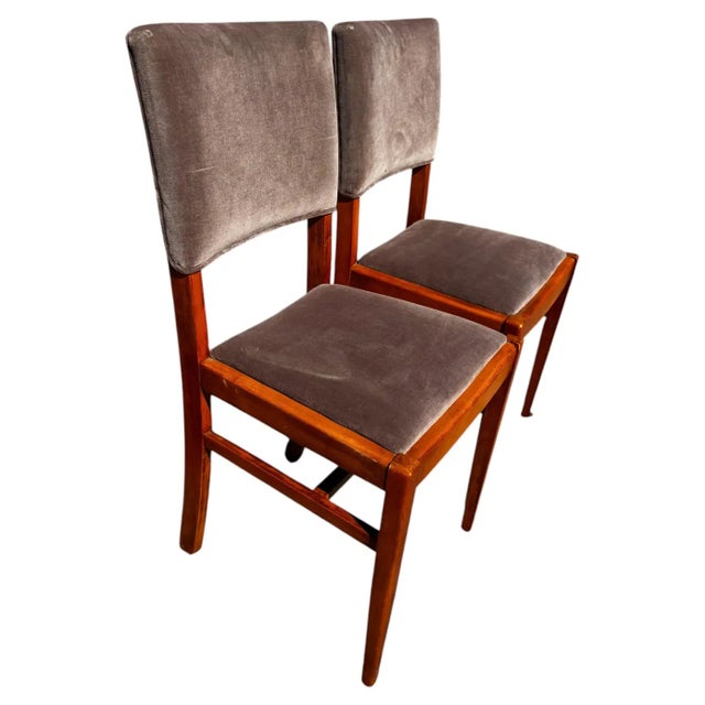 These chairs were made in Sweden. They're made of teak and have velour upholstery. They have a Danish Modern style.