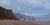 This oil painting captures a serene coastal scene, where soft, muted colors evoke a sense of tranquility and...