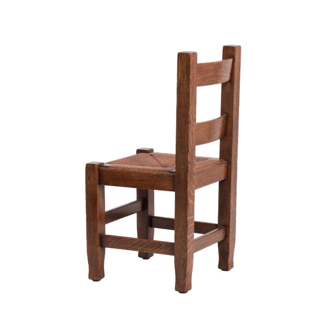 A rare, wonderful and incredibly rare set of four Arts & Crafts dining chairs by Joseph McHugh. Three of the chairs are...