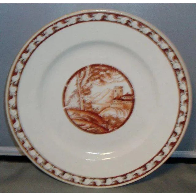 An export porcelain dish decorated with a central medallion depicting a landscape in sepia tones. Nice orange peel glaze...