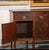 Dated to the early 1900s, this antique sideboard by Williams-Kimp Furniture exhibits beautiful eye catching inlaid flame...