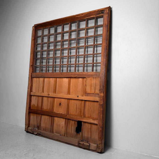 This large, original Japanese sliding door combines a clean wooden lattice with metal wire mesh and a solid lower section,...