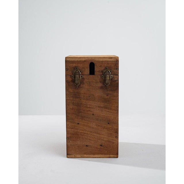 This wooden box was made in France, around the 19th century. Made of patinated brown mahogany, assembled with brass screws...