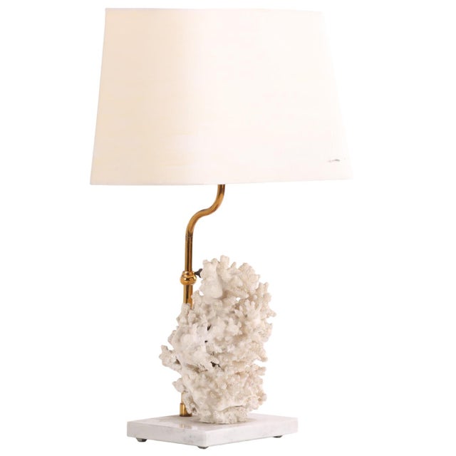 A striking naturalistic table lamp, the base formed from a substantial piece of genuine white branch coral, mounted on a...