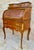 Elegant French bureau, featuring fine marquetry decoration and richly detailed gilt-bronze mounts. The curved upper...