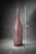 Elegant blush mauve art glass bud vase featuring a tall, slender bottle form and softly translucent finish. Its minimalist...