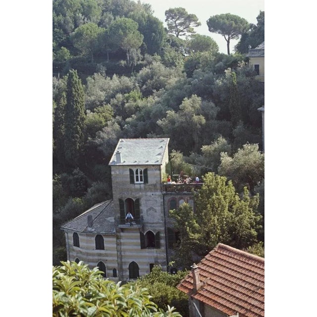 Portofino, Italy 1985 by Slim Aarons Slim Aarons Limited Estate Edition Guests relax on the terrace at the villa of...