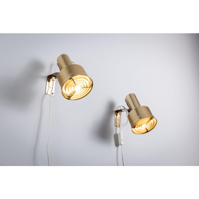 This elegant pair of gold wall lamps was designed by Per Sundstedt and produced by the renowned Swedish lighting company...