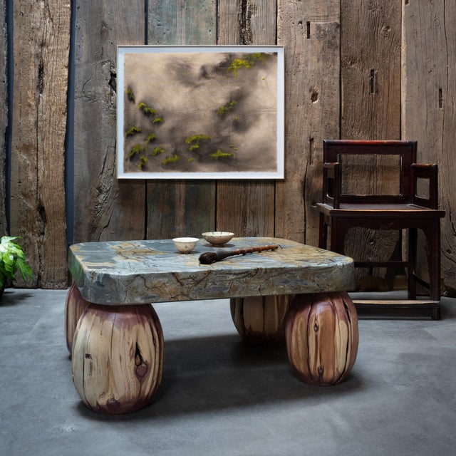 Marked with patterns of light and dark, this meditation stone table exemplifies organic modern style with an emphasis on...