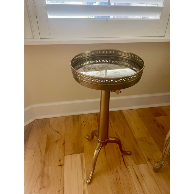 Mid-Century Modern French-style telescoping brass guéridon pedestal table. This style is commonly attributed to Maison...