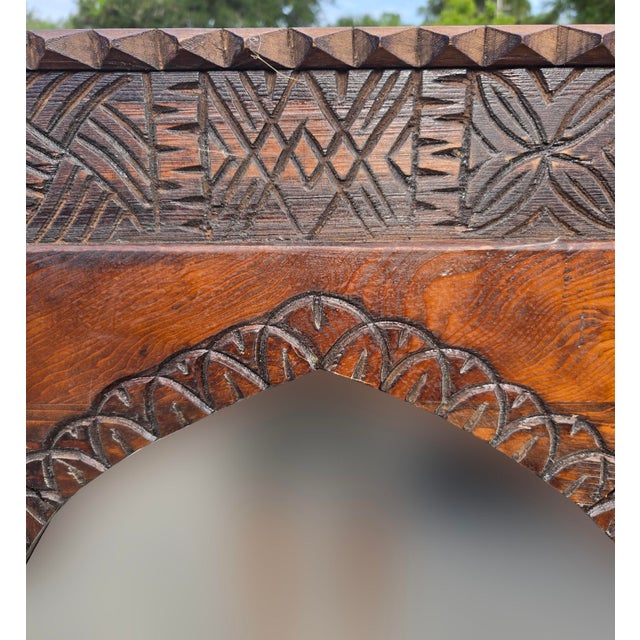 Handmade Berber‑style wooden mirror featuring intricate geometric carvings and a pointed‑arch glass center. Crafted with...