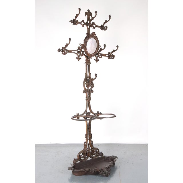 Victorian style hall tree made of cast iron with a coat of clear sealant. It features eight double arm hooks, a removable...