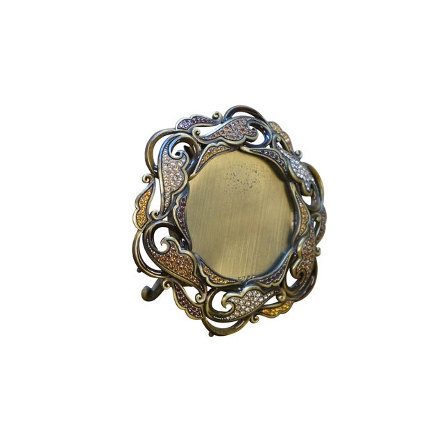 Late 20th century Jay Strongwater Carmela brass and Swarovski crystal miniature round picture frame. Swirling paisley...