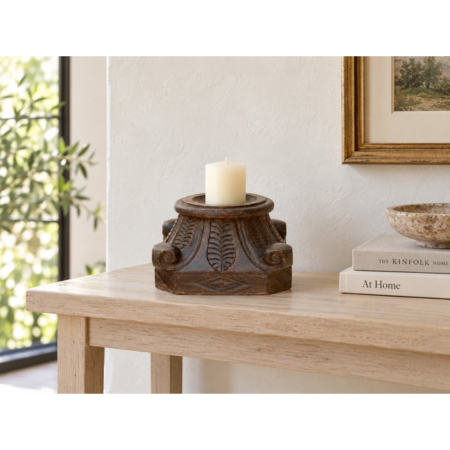 Look at the carving first. A single leaf rises from the center of each face, framed by tight scrolls at the corners and a...