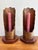 A matching pair of Arts & Crafts hammered copper candlestick holders on wood bases, hand-crafted in the mid 20th century....