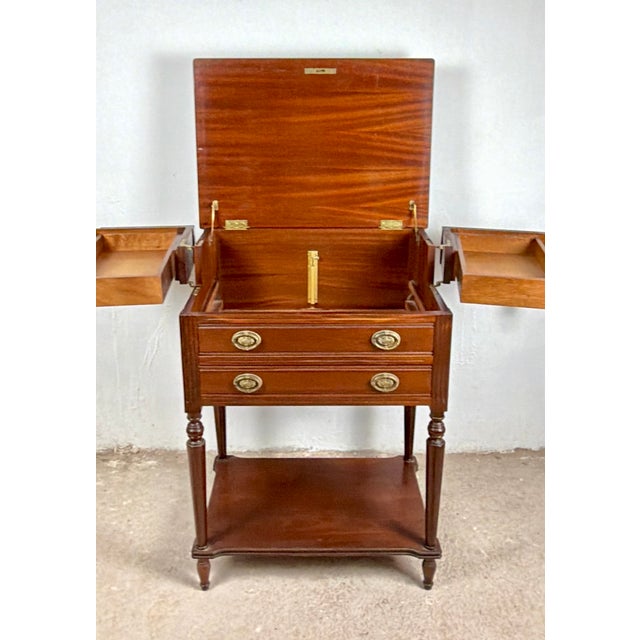 Distinctive pair of storage tables dating from circa 1970, combining elegant traditional styling with an ingenious and...