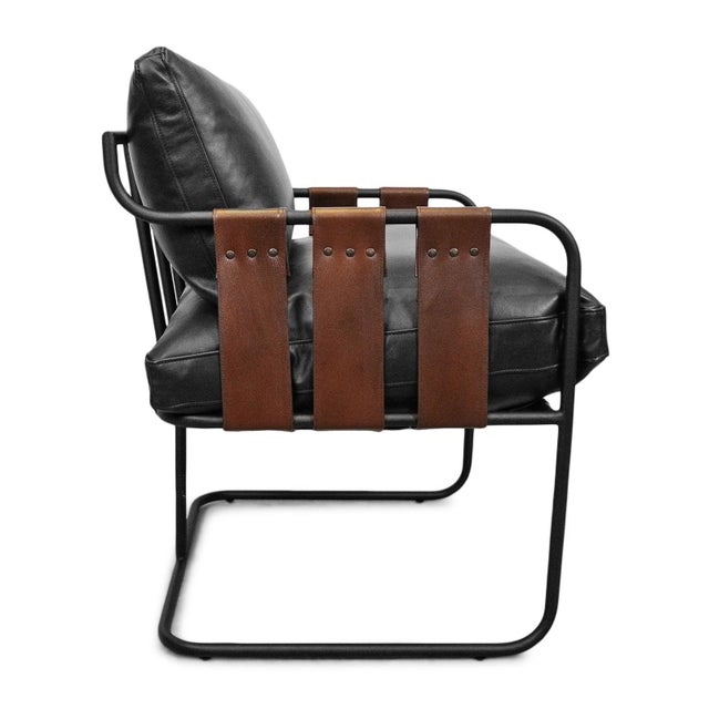 Handsome easy chair with black soft highest grade leather and rich brown leather straps on black iron frame. Wonderful...