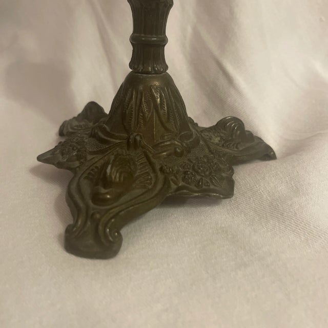 Antique metal candlestick with dolphin or koi, floral, swag garland, and classical decoration