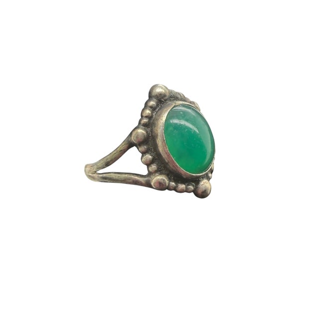This elegant vintage Georg Jensen ring from Denmark showcases a beautiful cabochon chrysoprase set in sterling silver. The...
