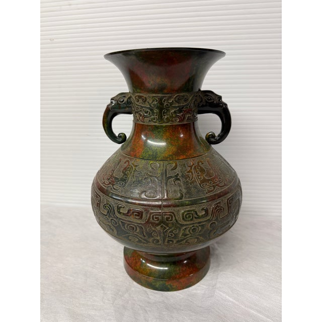 Design Plus Gallery presents an Antique Bronze Vessel from Japan. The striking metal vessel is colored richly in hues of...