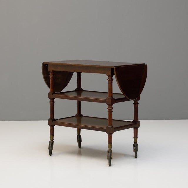 Three tier hotel / catering trolley in walnut with two drop leaves. Circa 1900.
