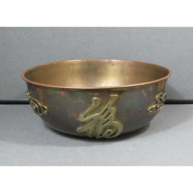 A handsome and quietly sophisticated 1960s brass centerpiece bowl from Hong Kong, this piece pairs clean architectural...