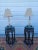 Pair of antique Asian Figural lamps made from pottery on a wooden base with shades and finials.