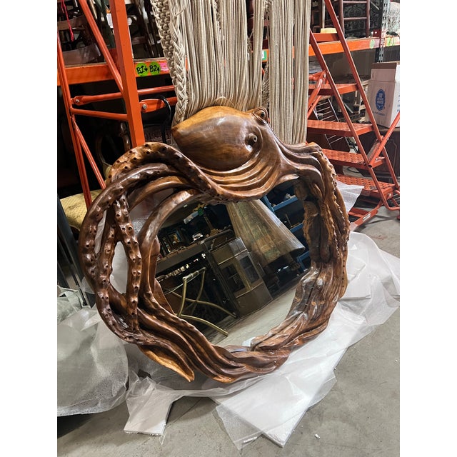 Elevate your space with this gorgeous hand, carved wooden octopus mirror. Perfect for a beach house or ocean front...