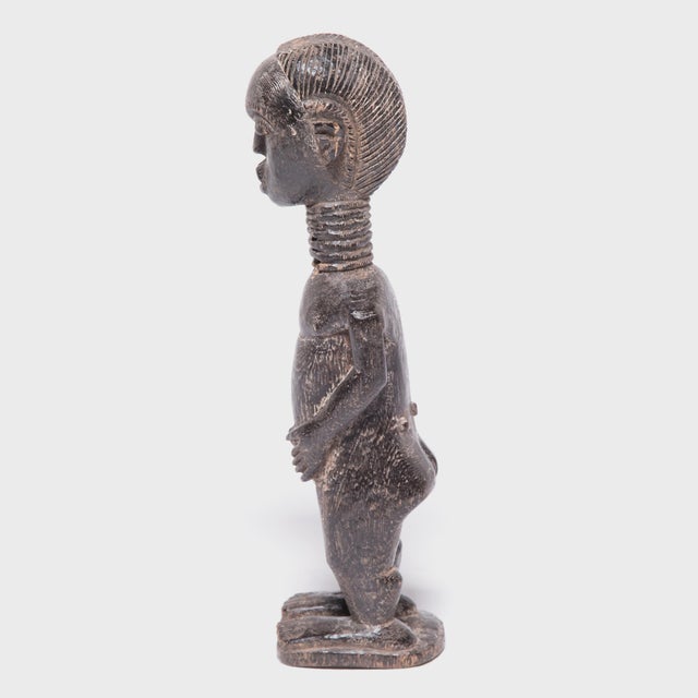 The figurative sculptures of the Baule peoples of Cote d'Ivoire are recognizable by their strong, gently curving forms and...