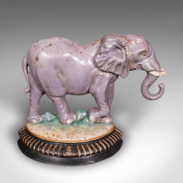 This is a delightful antique elephant doorstop. An English, handpainted cast iron decorative door keeper or mantel...