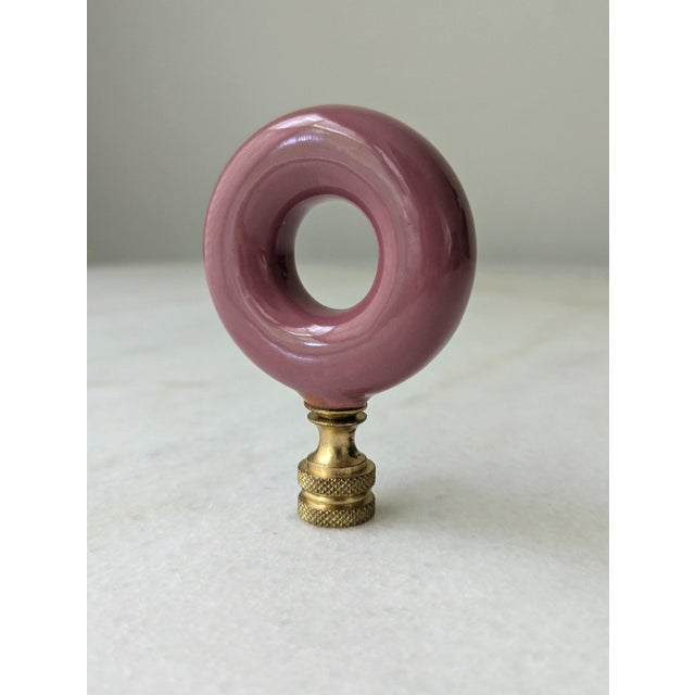 A colorful and unique vintage lampshade topper featuring an O-shaped glass finial with brass hardware. Dimensions: 3" H x 2"L