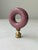 A colorful and unique vintage lampshade topper featuring an O-shaped glass finial with brass hardware. Dimensions: 3" H x 2"L