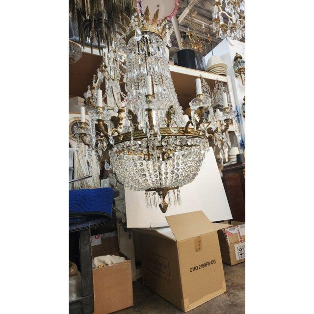 This listing features a rock crystal and brass chandelier with 24 lights. A larger size chandelier that is approx. 47" in...