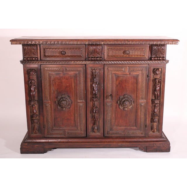 Antique baroque style carved walnut credenza, 19th century. With a rectangular two board top with molded front and side...
