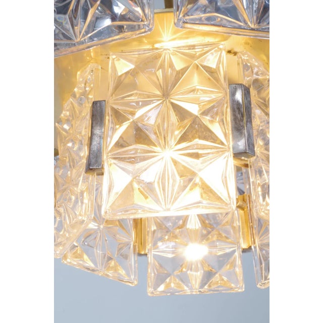 Chandelier fom Kinkeldey, Germany. The prisma glass parts are spreading a warm light. I have official proof of...