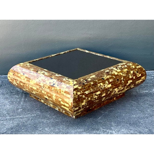 This striking coffee table is a quintessential example of 1970s Hollywood Regency opulence, blending organic textures with...