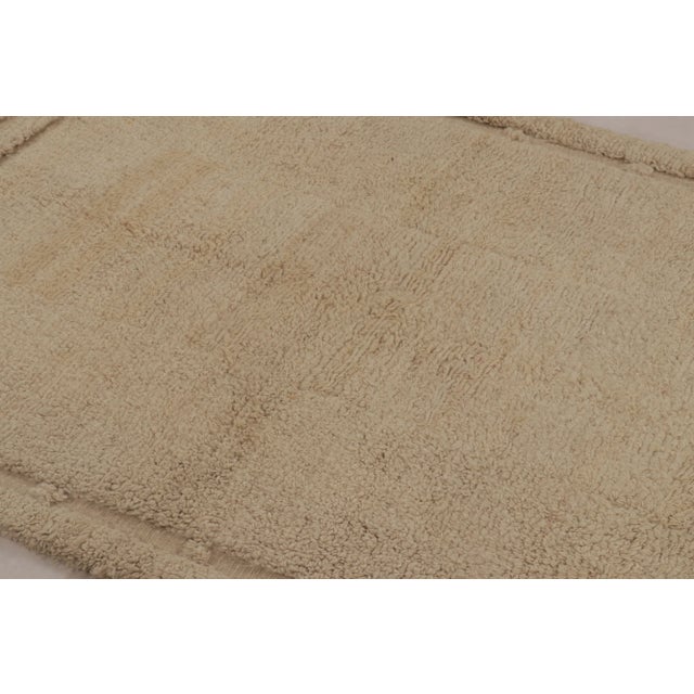 Made with hand-knotted high-pile wool in Turkey, this 5x4 vintage Tulu rug is a distinguished addition to Rug & Kilim’s...