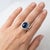 Elegant and timeless, this 14K white gold ring features an oval cabochon blue sapphire weighing approximately 4.76 carats,...