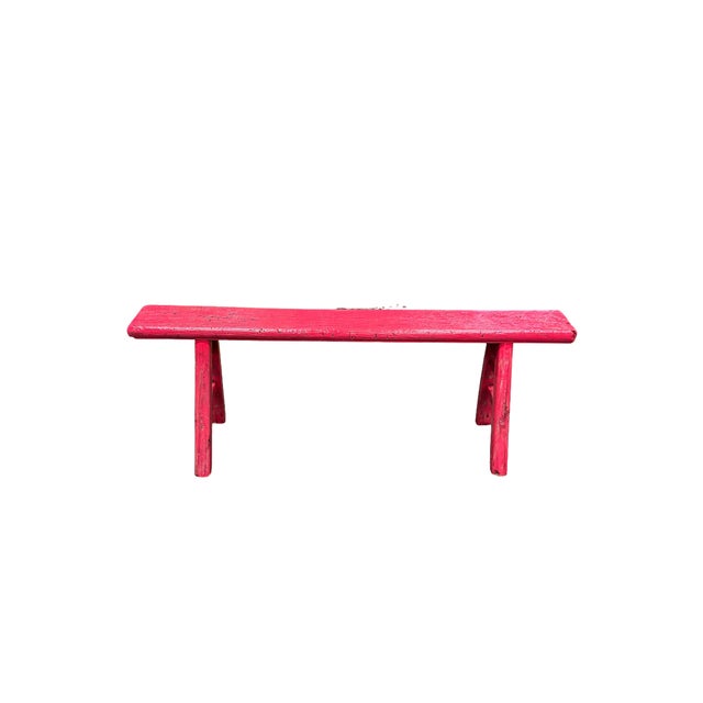 This long vintage wooden bench features a vibrant hot pink lacquer finish that instantly draws the eye. Crafted with...